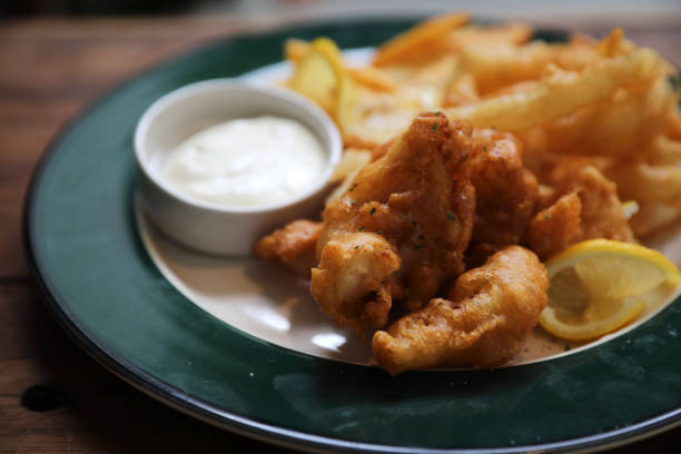 istock Fish and chips fried fish and potatoes on wood background vintage style 1147685132