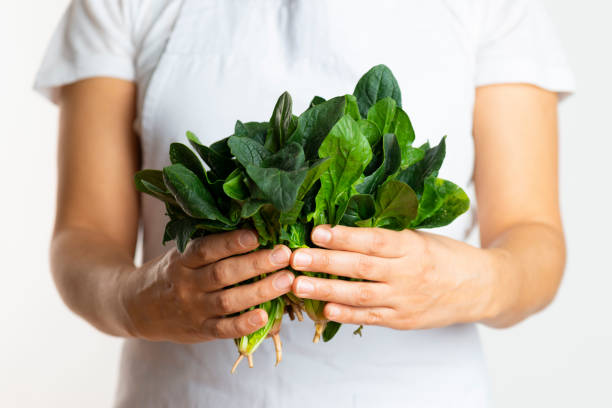 istock Woman with fresh spinach 1147693256