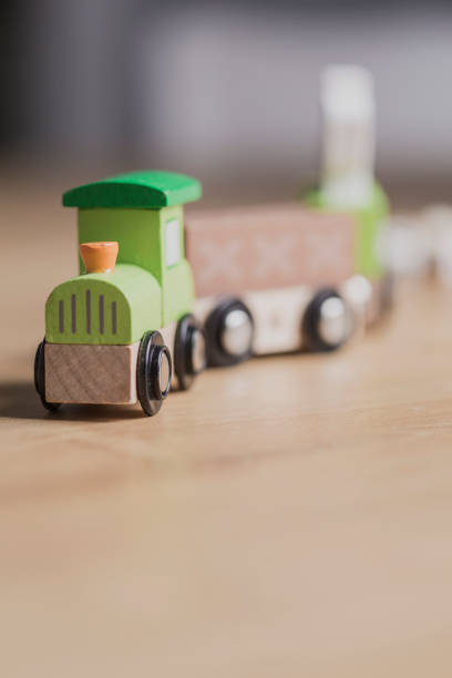 istock Green toy wooden train close up still 1147693357