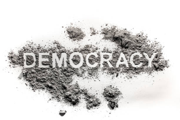 istock Democracy word text written in dirt, ash, sand 1147700138