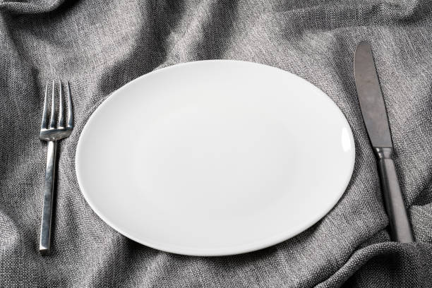istock plate fork spoon on fabric clothes background clear and without depth of field 1147706958