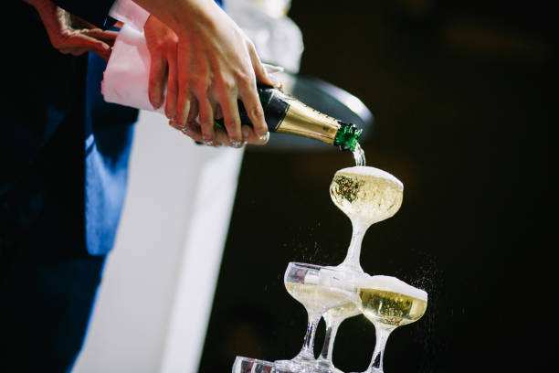 istock Pouring Champaign into glasses tower in wedding reception 1147709902