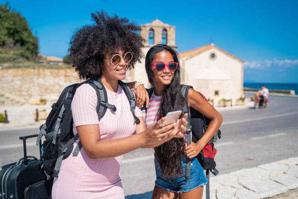 istock Tourists with luggage looking for direction and using smart phone in Zakynthos Greece 1147711769
