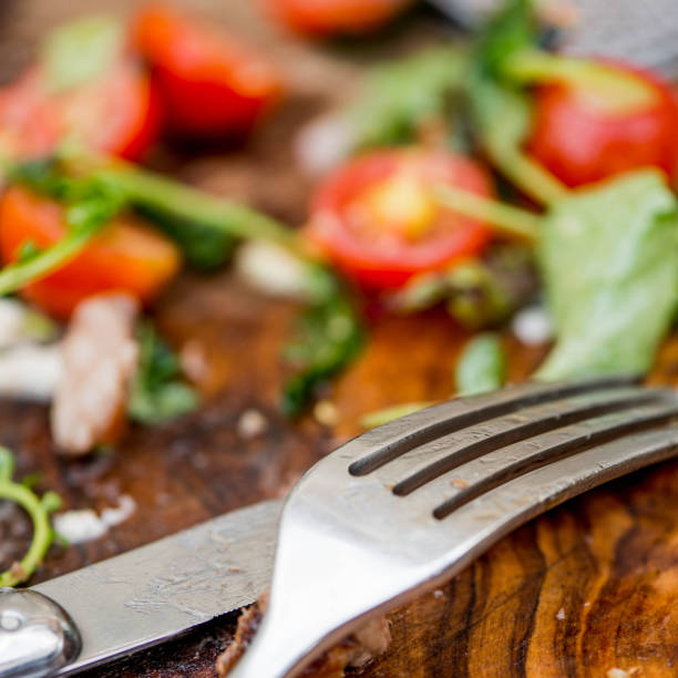 Salad Left Overs From a Meal With a Knife and Fork