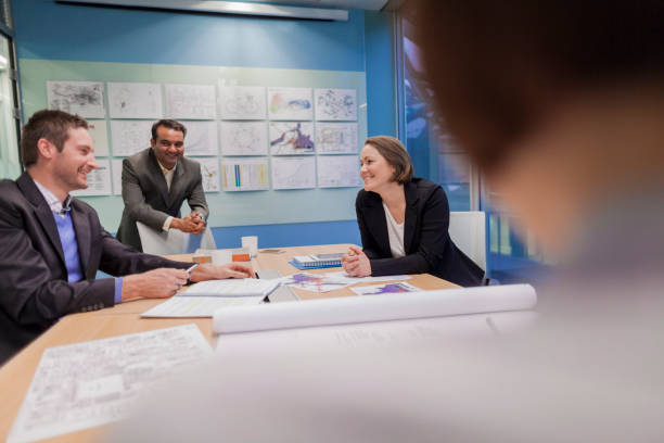 istock Colleagues talking in design office meeting room 1147713528