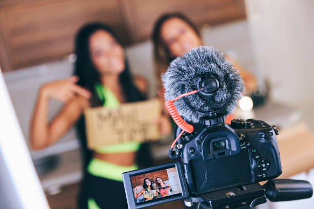 istock Two vloggers filming a video, focus on foreground 1147713713