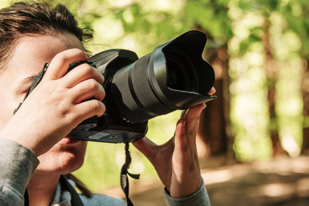 istock Woman taking a picture with a DSLR camera 1147717679