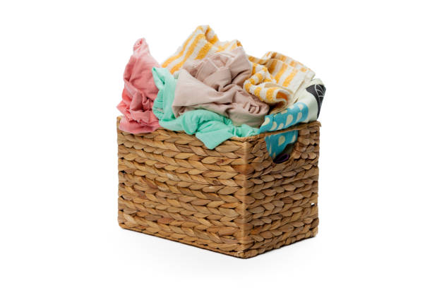 istock Clothes in a laundry wooden basket isolated on white background 1147719434