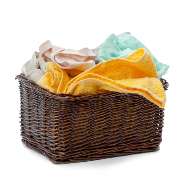 istock Clothes in a laundry wooden basket isolated on white background 1147719658