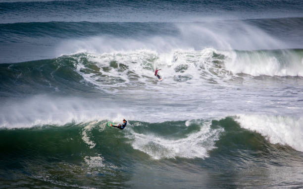 Filipe Toledo (foreground) winning over Ryan Callinan at monster swells of Bells Beach. stock photo