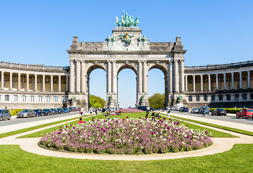 Brussels, Belgium - April 18, 2019: The arcade du Cinquantenaire, the triumphal arch erected in 1905 by king Leopold II in the Cinquantenaire park, on a sunny day.