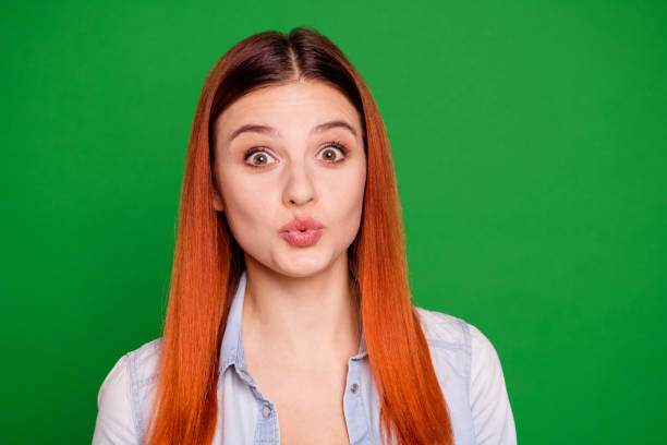 close up photo attractive lovely teen teenager attract boys men send kisses feel foolish careless have free time weekend holidays hairdo long straight dressed modern jeans isolated green background - long hair red hair women men imagens e fotografias de stock