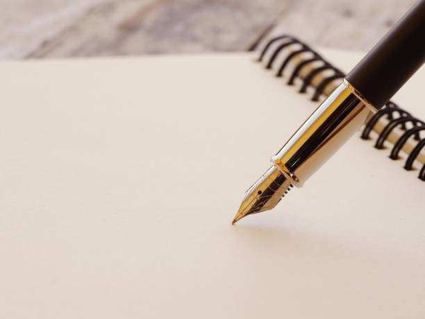 istock Close-Up Of Pen And Book 1147725504