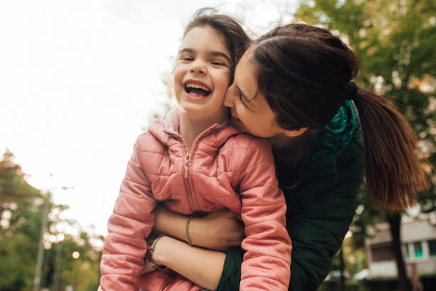 istock Woman kissing her daughter 1147730475