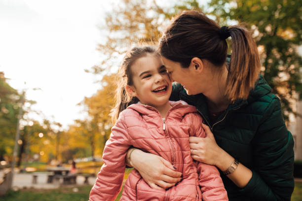 istock Cheerful woman cuddling with her daughter 1147730522
