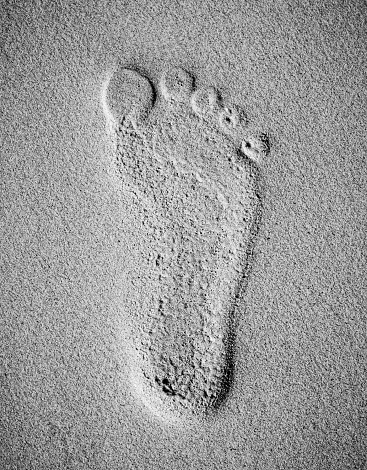 Background of footprint on sand at the beach with black and white color