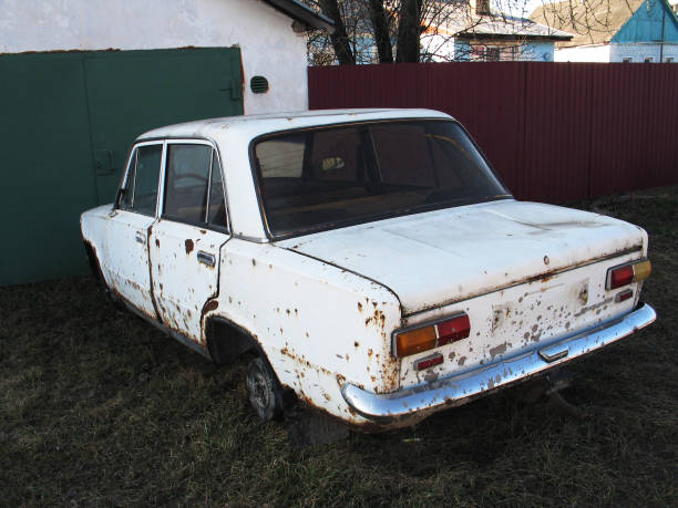 istock old rusty white car without wheels outdoor 1147738236