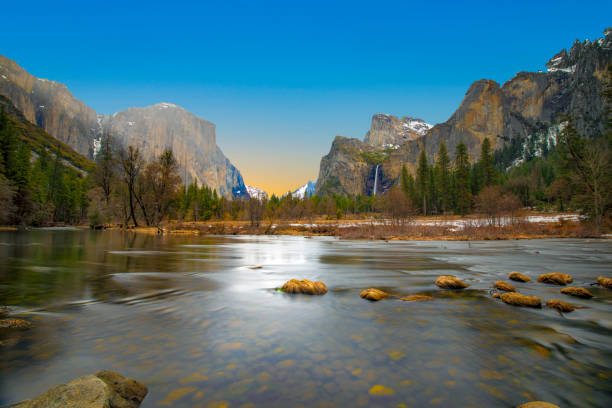 istock beautiful view in Yosemite valley with half dome and el capitan from Merced river 1147738307