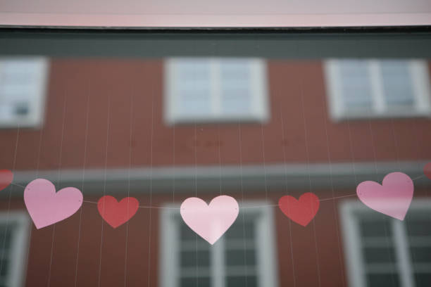 Heart painted on the misted glass of the window close up