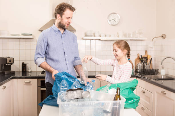 istock Recycling - family sorting (segregating) household waste 1147738517
