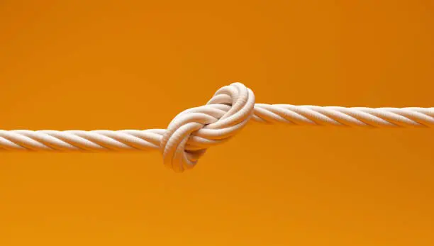 Photo of Knotted Rope on isolated Yellow Color Background