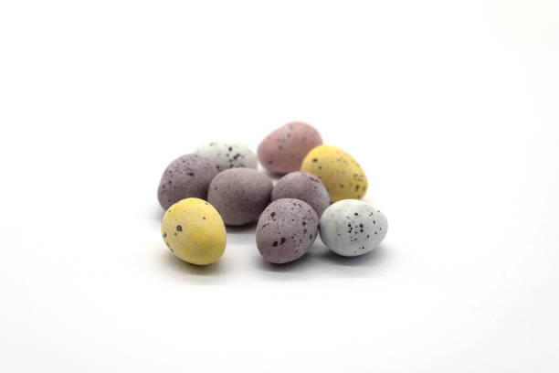istock Miniature Chocolate Eggs in a Pile on a White Background 1147740140