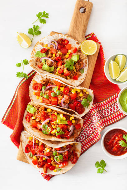 istock mexican beef and pork tacos with salsa, guacamole and vegetables 1147741519