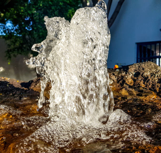 istock water source in the foreground with transparent water jet and background sunlight 1147741596