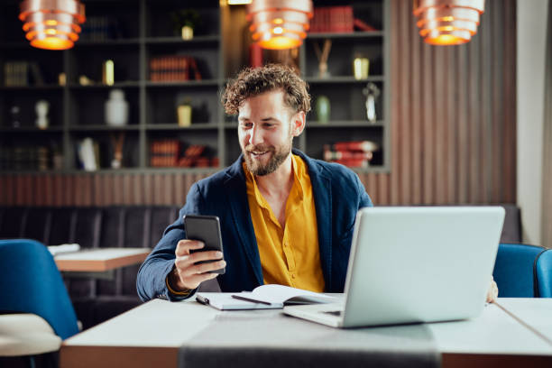 istock Businessman using smart phone in cafe. 1147742482