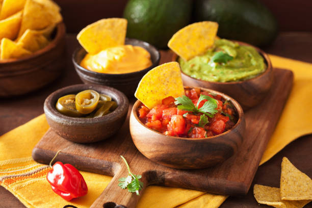 istock mexican nachos with guacamole, salsa and cheese dip 1147742762