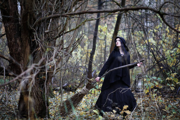 istock A woman in a witch suit in a forest 1147745637