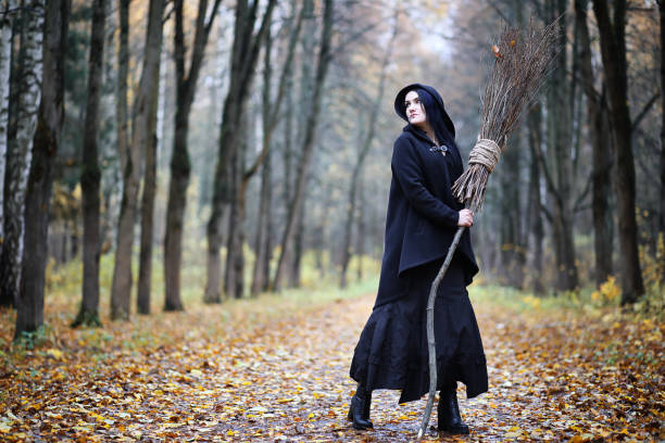 istock A woman in a witch suit in a forest 1147745686