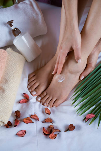istock Applying moisturizer to woman's feet 1147747444