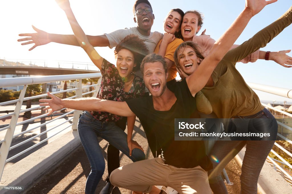 Portrait Of Young Friends Outdoors Posing On Gangway Together Friendship Stock Photo