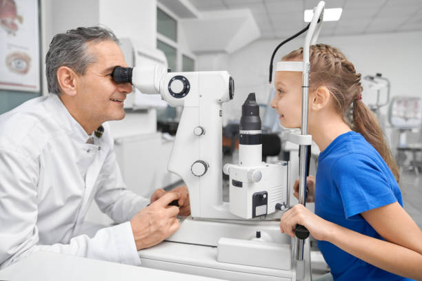 istock Doctor ophthalmologist examining eyes with test machine. 1147759089