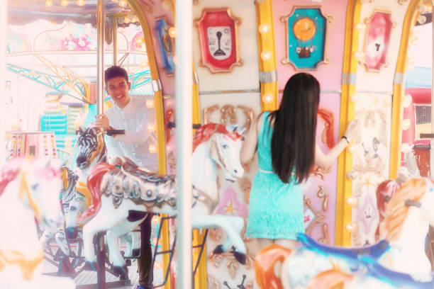 istock Young couple on a date at the fair 1147760524