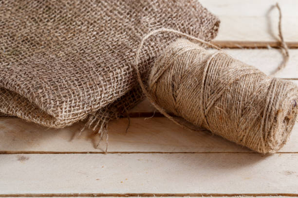 istock the canvas and the tangle of thread on a wooden background 1147762676