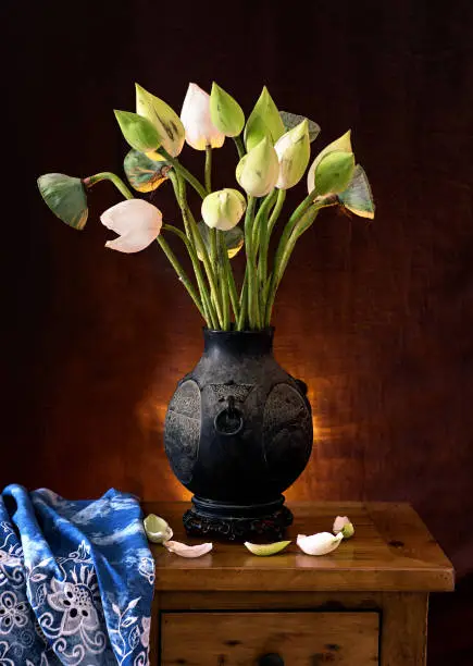 White lotus flower and antique vase, still life, stock photo