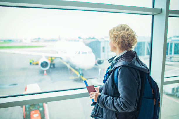 istock Woman holding passport and boarding pass 1147763155