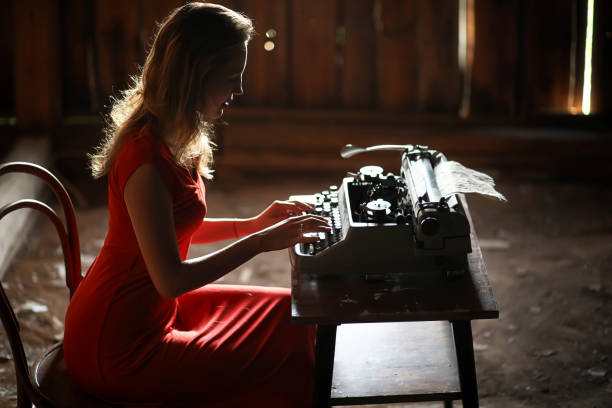 istock A girl in retro style prints on an old typewriter 1147765226