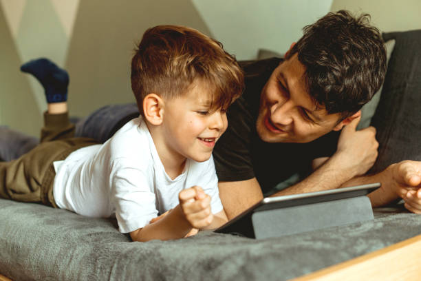 istock Father and son looking at digital tablet 1147765717