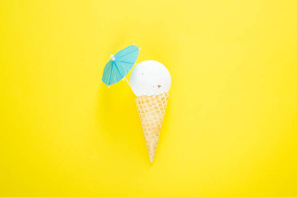 istock Composition of ice cream cone with white bath ball and beach umbrella 1147767642