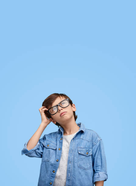 istock Little boy scratching head in contemplations 1147768068