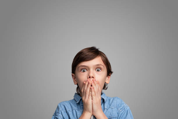 istock Shocked boy covering mouth 1147768098