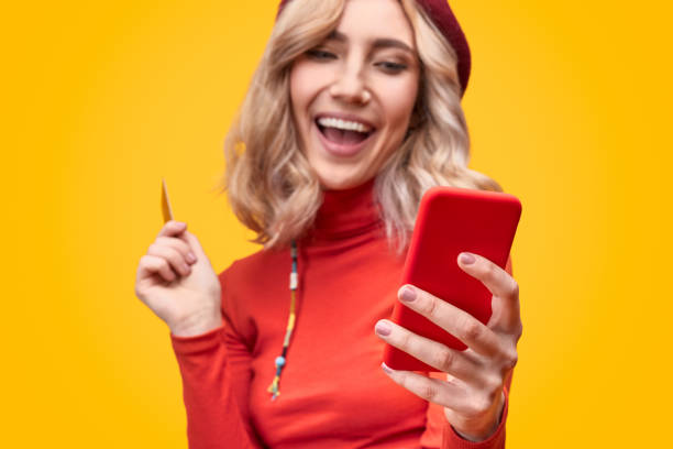 istock Excited female browsing smartphone 1147768187