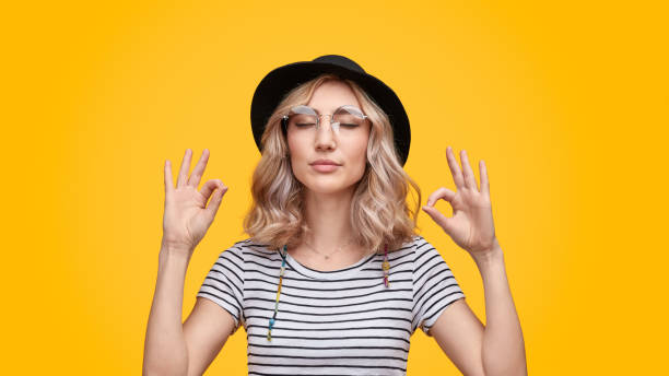 istock Stylish lady meditating with closed eyes 1147768218