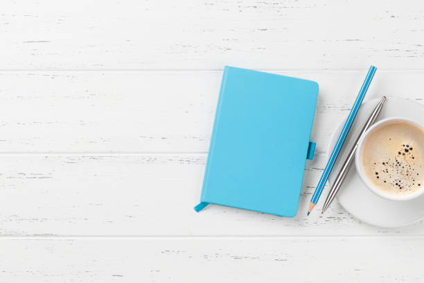 istock Office desk with coffee cup and supplies 1147769287