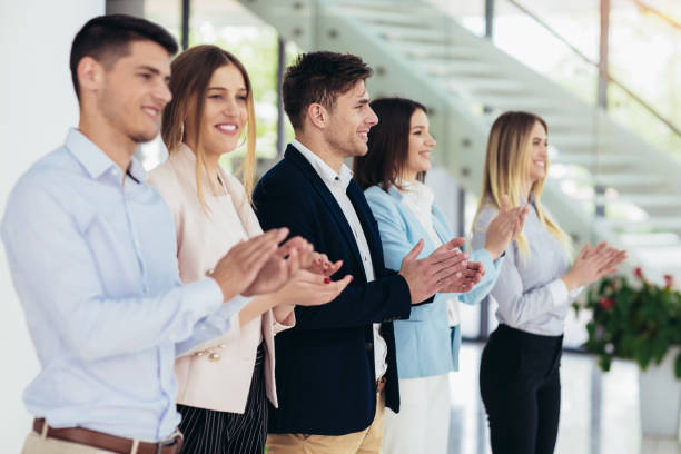 istock Group of businesspeople clapping in office. 1147770157