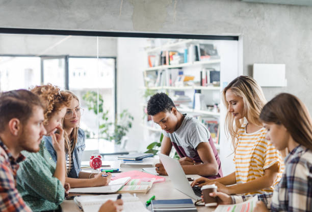istock Large group of university students learning together in library. 1147770517