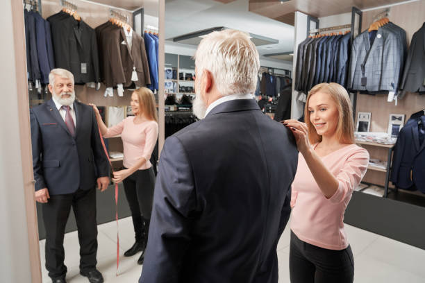 istock Elder man trying on formal suit in clothes shop 1147770923
